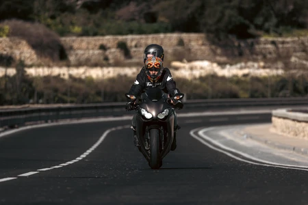 Motorcyclist on a Curved Road