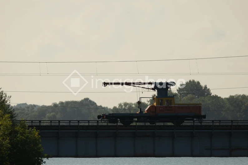 Silhouette of a Construction Train on a Bridge